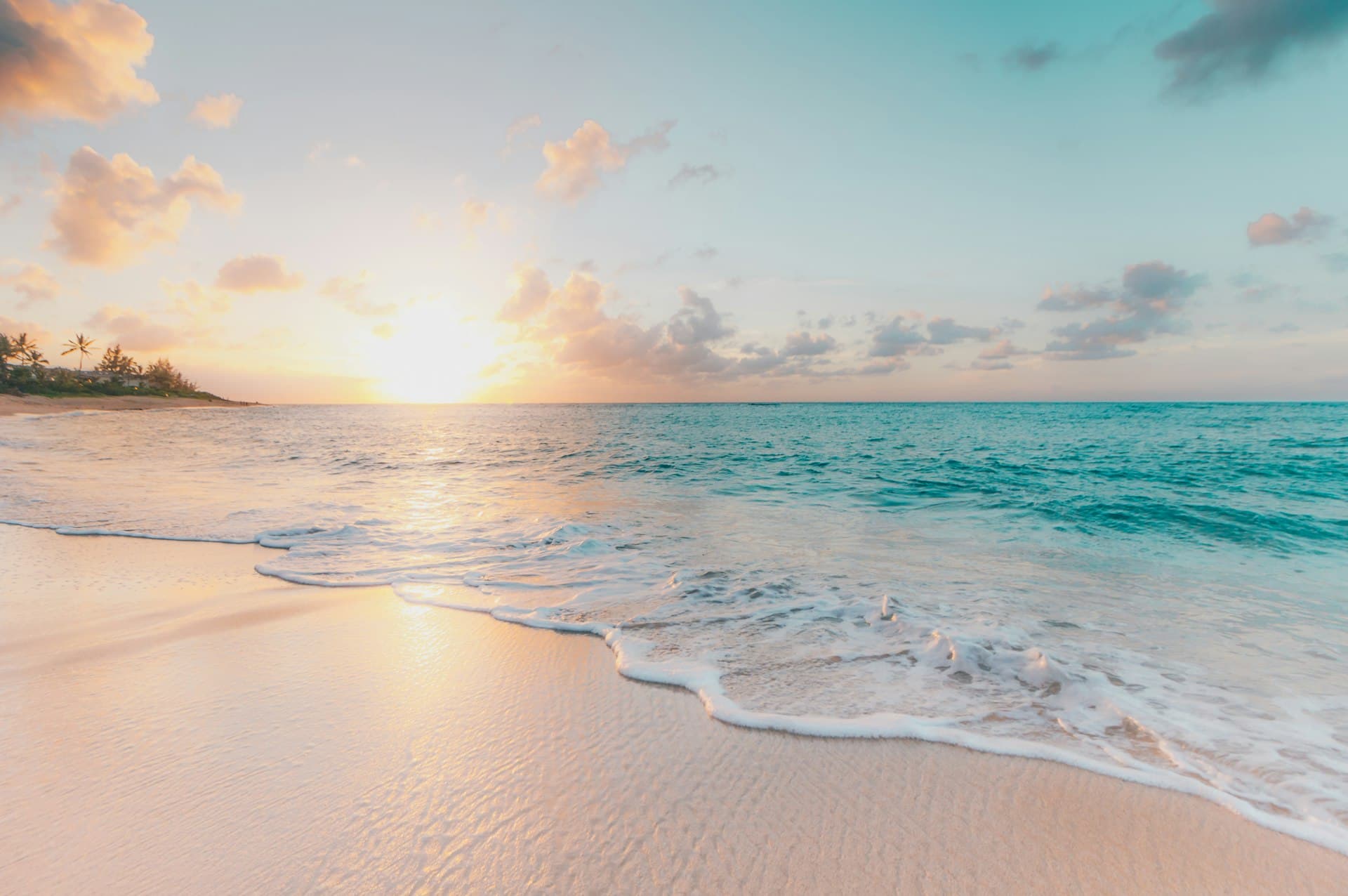 Sunrise over a tropical Caribbean beach, the kind of shoreline golf carts serve on Ambergris Caye and Caye Caulker in Belize